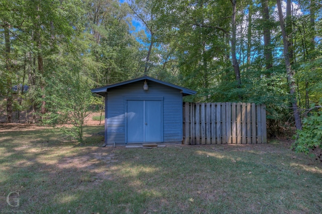 view of outbuilding with a yard