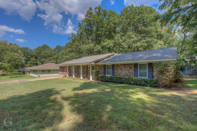 ranch-style home with a front lawn