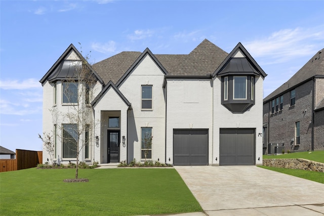 view of front of home featuring central AC, a garage, and a front lawn