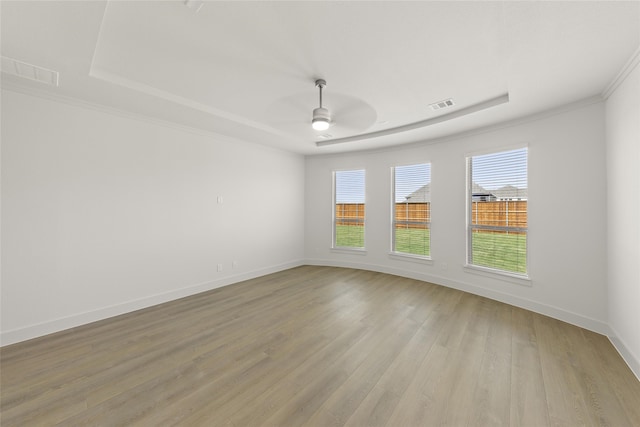 unfurnished room with ceiling fan, ornamental molding, and light wood-type flooring