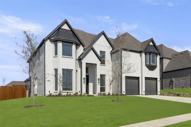 view of front of house featuring a garage and a front lawn