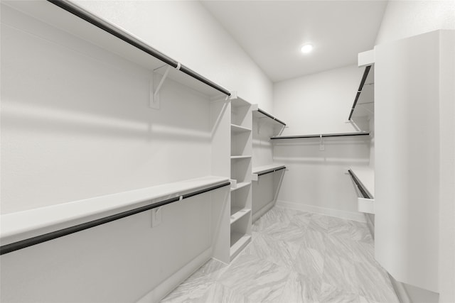 981 Stanford Ln, Prosper, TX 75078 - walk in closet featuring marble finish floor