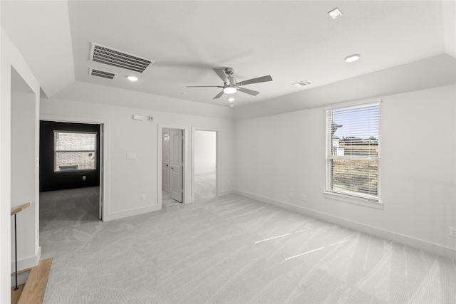 unfurnished bedroom featuring vaulted ceiling, light colored carpet, and ceiling fan