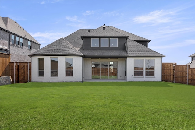 981 Stanford Ln, Prosper, TX 75078 - rear view of house featuring a yard, brick siding, roof with shingles, and a fenced backyard
