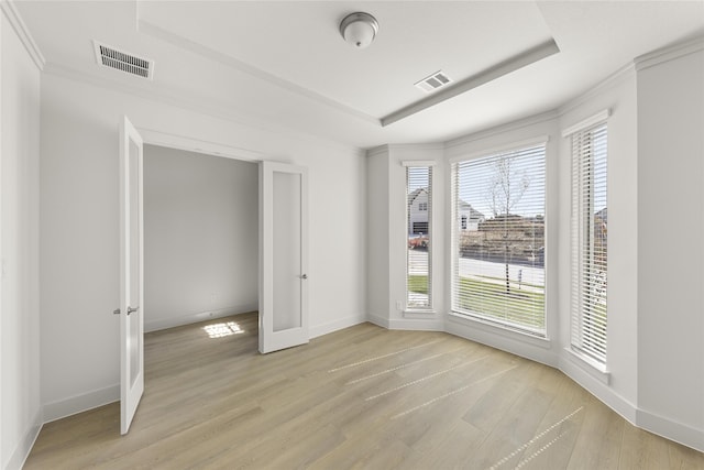 981 Stanford Ln, Prosper, TX 75078 - interior space featuring baseboards, light wood-style floors, a tray ceiling, and visible vents