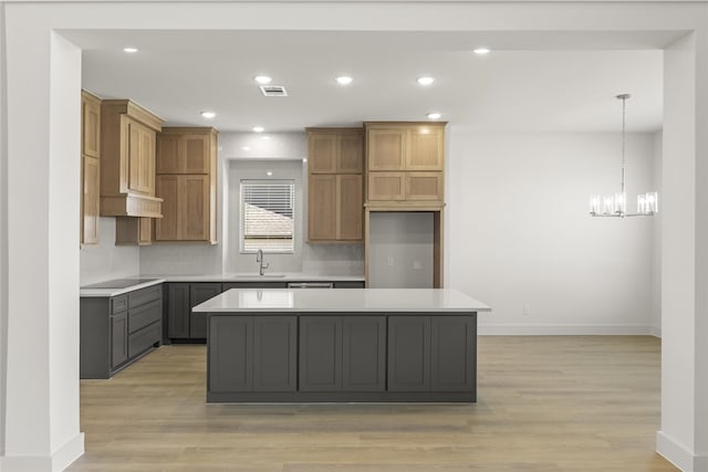 kitchen featuring light hardwood / wood-style floors, pendant lighting, and a kitchen island