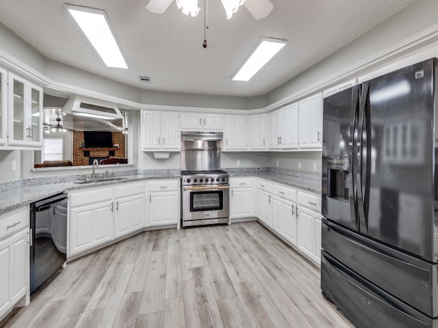 kitchen featuring black appliances, ceiling fan, white cabinetry, and light hardwood / wood-style floors