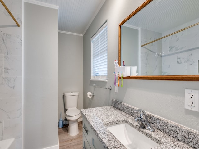 full bathroom with vanity, wood-type flooring, toilet, ornamental molding, and tiled shower / bath combo