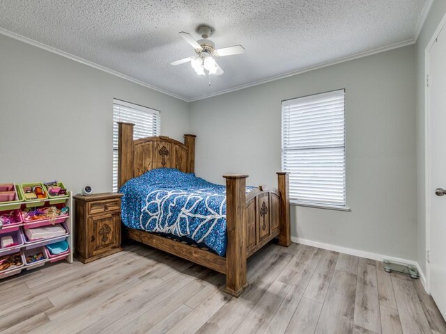 bedroom with light wood-type flooring, ceiling fan, ornamental molding, and a textured ceiling