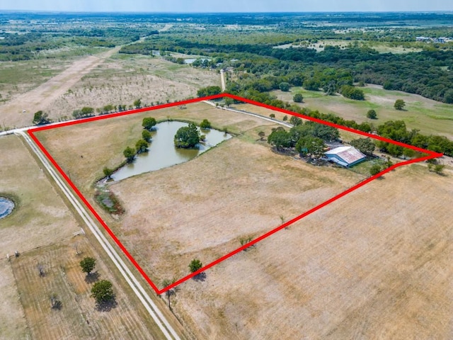 birds eye view of property with a rural view and a water view