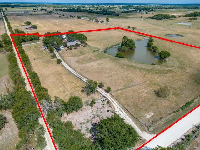 birds eye view of property featuring a rural view and a water view