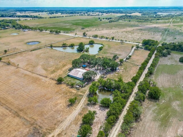 drone / aerial view featuring a water view and a rural view