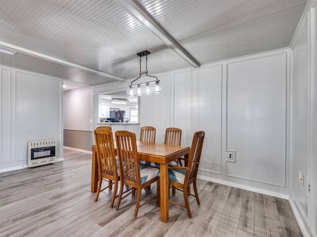 dining area featuring heating unit and light hardwood / wood-style flooring