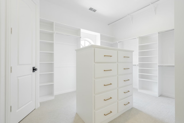 walk in closet with light carpet and visible vents