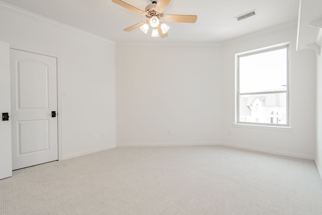 spare room with ceiling fan, a wealth of natural light, and light colored carpet