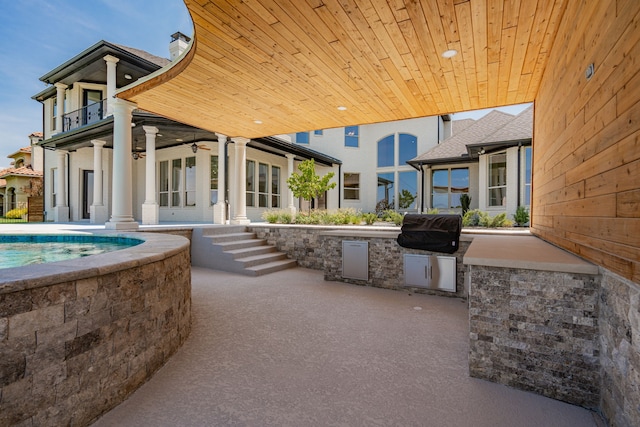 view of patio / terrace featuring an outdoor kitchen, a swimming pool, ceiling fan, and a grill