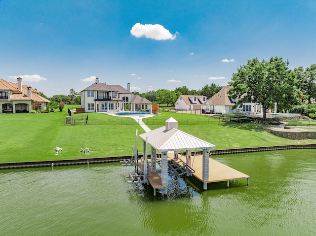 view of dock featuring a water view, a lawn, a patio, and a pool