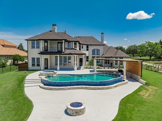 view of swimming pool featuring a patio, a lawn, and an in ground hot tub