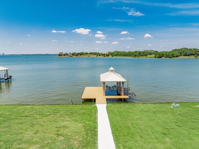 view of dock featuring a water view and a lawn