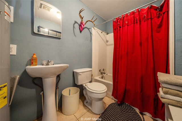 bathroom featuring toilet, shower / tub combo with curtain, and tile patterned floors