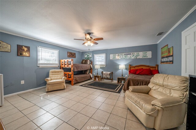 bedroom with multiple windows, ceiling fan, a textured ceiling, and light tile patterned flooring