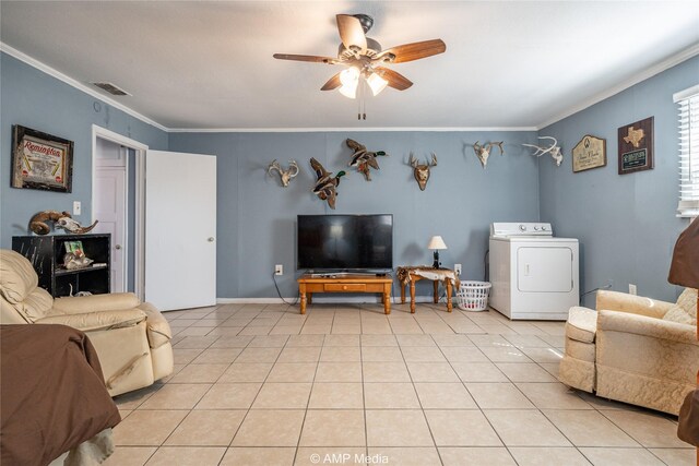 tiled living room with crown molding, ceiling fan, and washer / clothes dryer