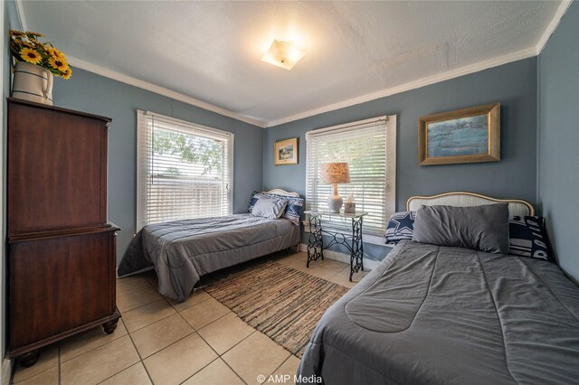 bedroom with light tile patterned floors and ornamental molding