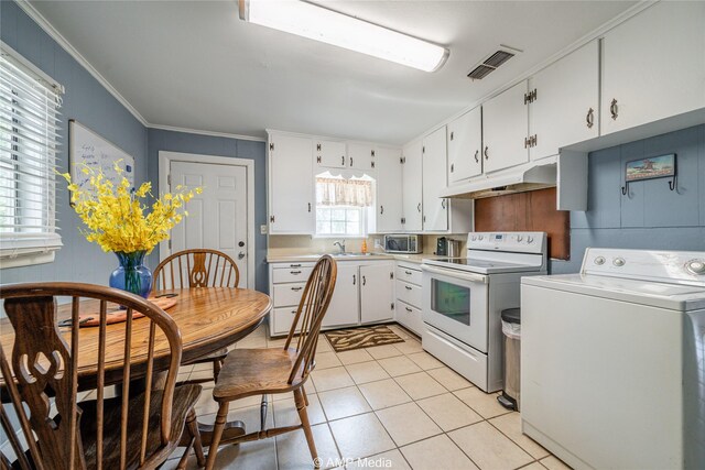 kitchen with washer / clothes dryer, light tile patterned floors, electric range, and white cabinetry