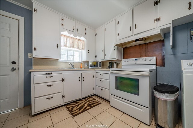 kitchen featuring white cabinetry, light tile patterned floors, sink, electric range, and washer / clothes dryer