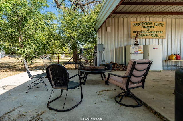 view of patio with a fire pit