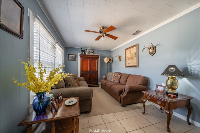 living room featuring ceiling fan, ornamental molding, and light tile patterned floors