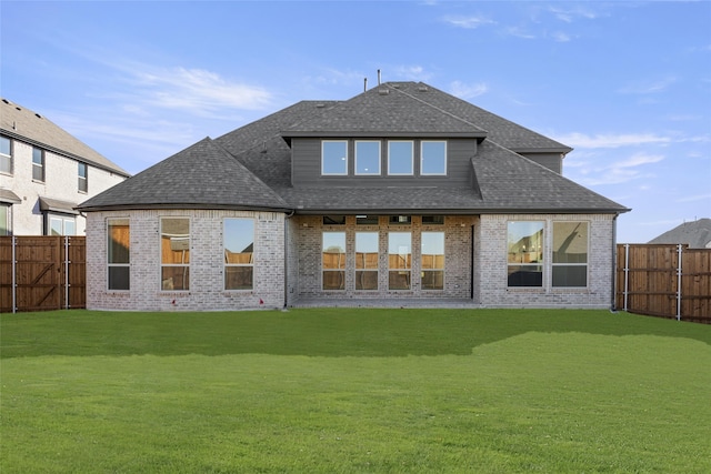 rear view of house with a yard