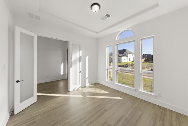 empty room featuring crown molding and hardwood / wood-style floors