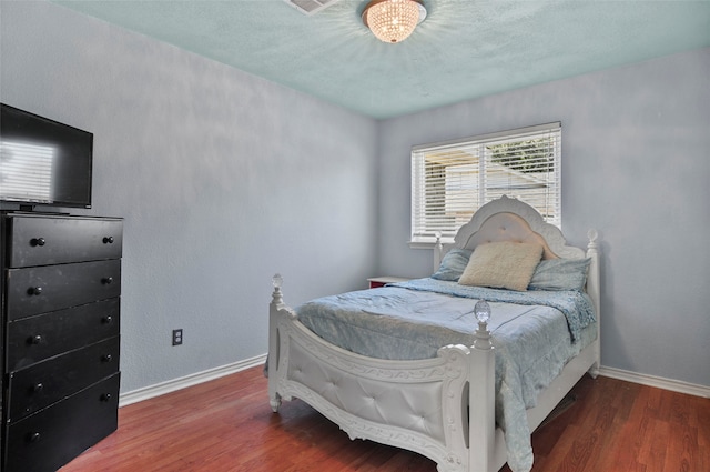 bedroom featuring dark wood-type flooring