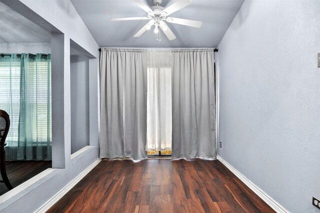 empty room featuring ceiling fan and dark hardwood / wood-style floors