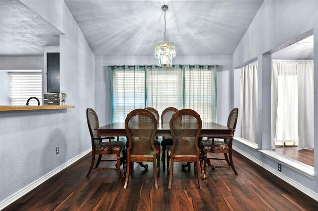 dining space featuring lofted ceiling, an inviting chandelier, and dark hardwood / wood-style flooring