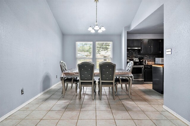 dining room with lofted ceiling, light tile patterned floors, and a notable chandelier