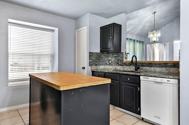 kitchen with tasteful backsplash, light tile patterned floors, sink, a center island, and white dishwasher