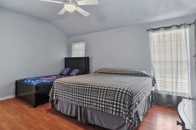 bedroom with lofted ceiling, ceiling fan, and dark hardwood / wood-style flooring