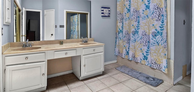 full bath with tile patterned floors, a sink, a shower with shower curtain, and double vanity