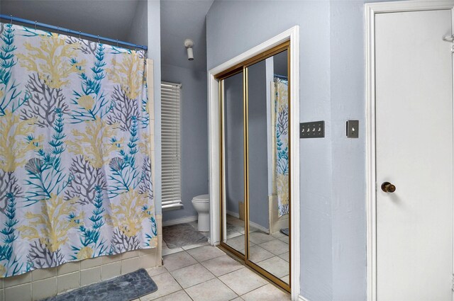 bathroom with tile patterned flooring and toilet