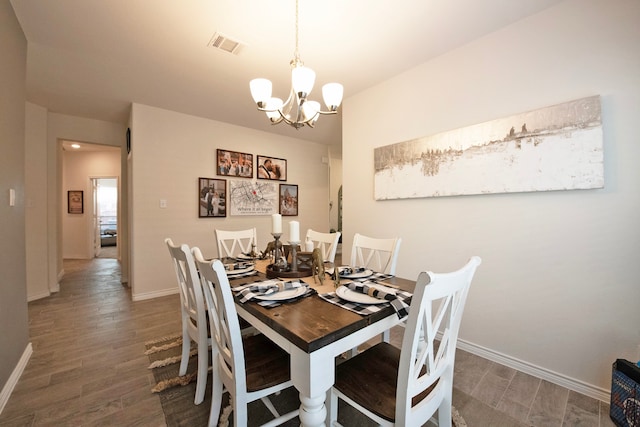 dining space with a notable chandelier and hardwood / wood-style flooring