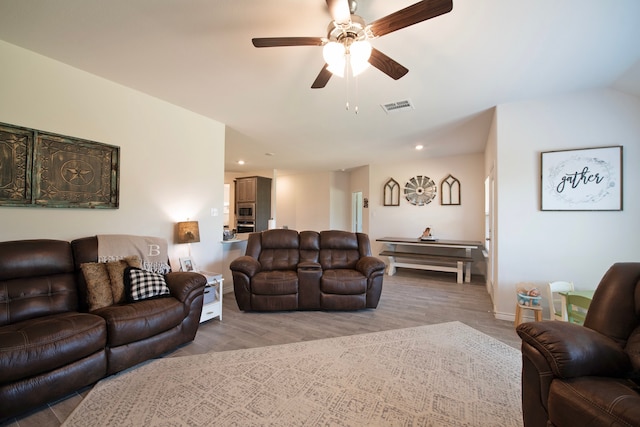 living room featuring ceiling fan and light hardwood / wood-style flooring