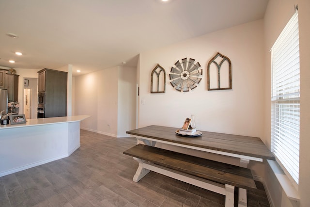 dining space with dark wood-type flooring