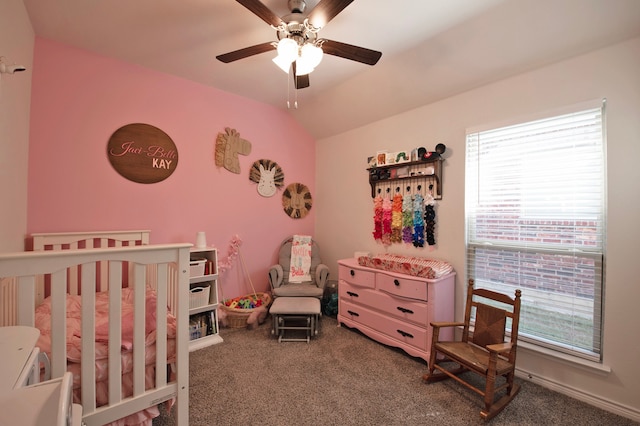 bedroom with a nursery area, ceiling fan, and carpet