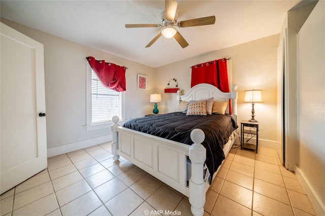 bedroom featuring a ceiling fan, baseboards, and light tile patterned floors