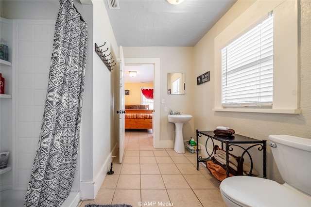 bathroom featuring a stall shower, visible vents, toilet, and tile patterned floors