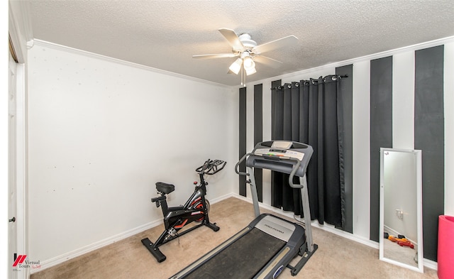 exercise area with ornamental molding, a textured ceiling, light colored carpet, and ceiling fan