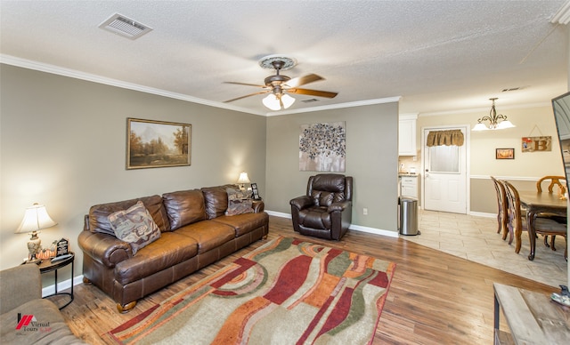 entrance foyer featuring crown molding, light tile patterned flooring, and a textured ceiling