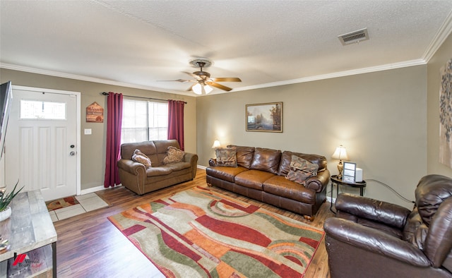 living room with crown molding, a textured ceiling, wood-type flooring, and ceiling fan